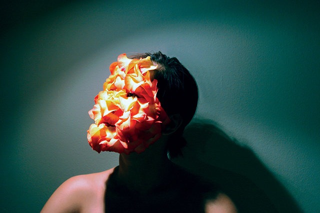 Man with a digital layer of orange curls over his face representing augmented reality