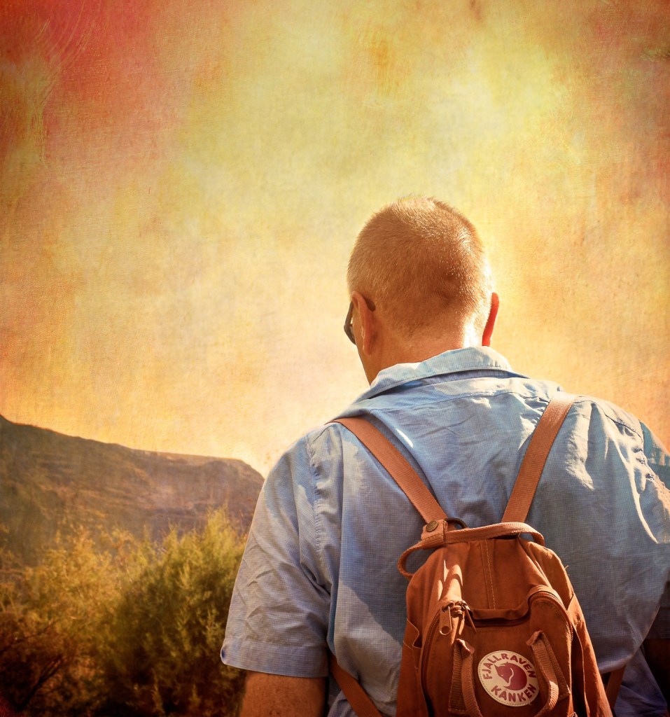 Alexius Jorgensen walking toward mountain sunset representing Duality Hack 11: Going without distance to non-duality
