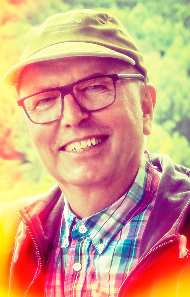 Alexius Jorgensen smiling big in nature pretending to appear as a finite entity in time