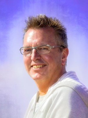 Alexius Jorgensen portrait with blue sky illustrating practical tools to hack duality.