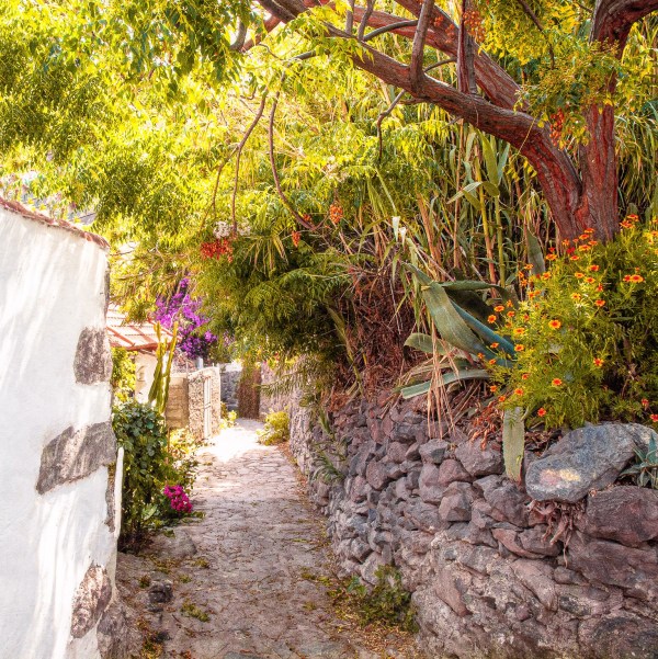 A highly romantic arched entrance built by nature leading into an old styled village layout
