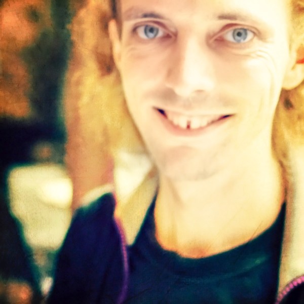 Blurred digital artwork in bright yellow hues depicting a happily smiling young man