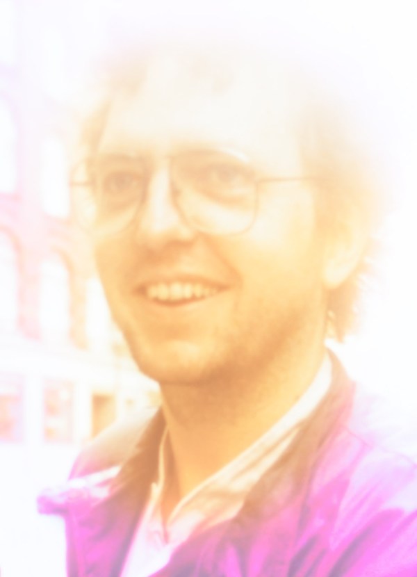 Alexius Jorgensen smiling and surrounded by white light representing formless Oneness
