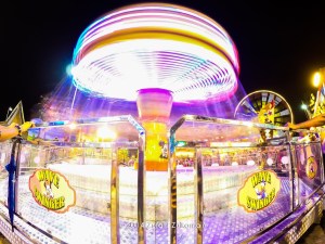 Spinning carousel lights merging at night illustrating Duality Hack 10.2 portal