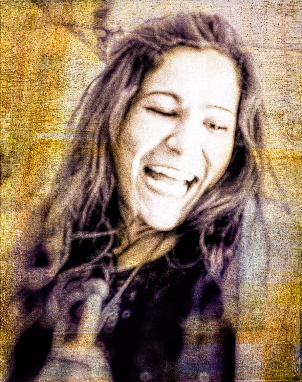Artistic sepia portrait photo of a young woman looking extremely happy